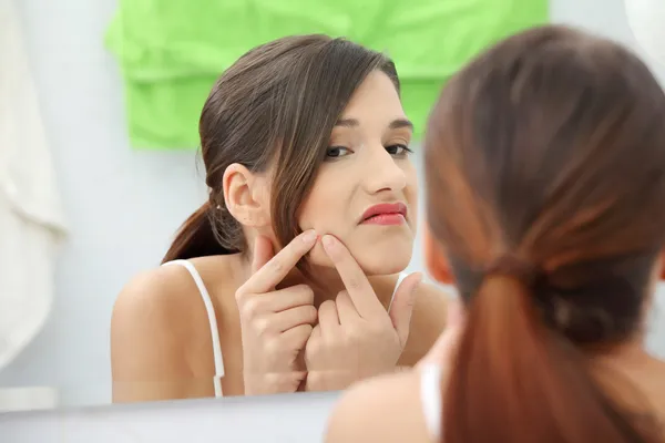 Young teenage woman with pimple — Stock Photo, Image