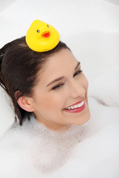 Beautiful young caucasian woman taking a bath — Stock Photo, Image