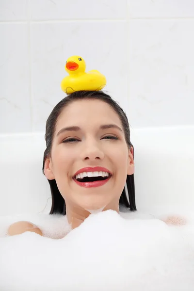 Beautiful young caucasian woman taking a bath — Stock Photo, Image