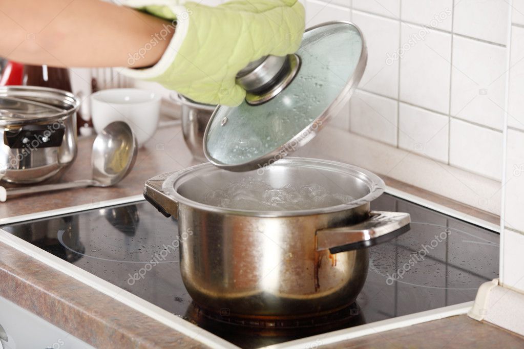 Young woman boiling something in pot