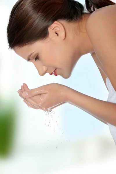 Young beautiful female washing her face — Stock Photo, Image