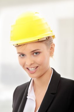 Confident female worker in helmet clipart