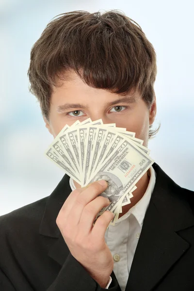 Jovem empresário bonito segurando dólares — Fotografia de Stock