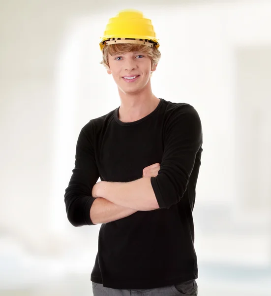 Young casual man in yellow helmet — Stock Photo, Image