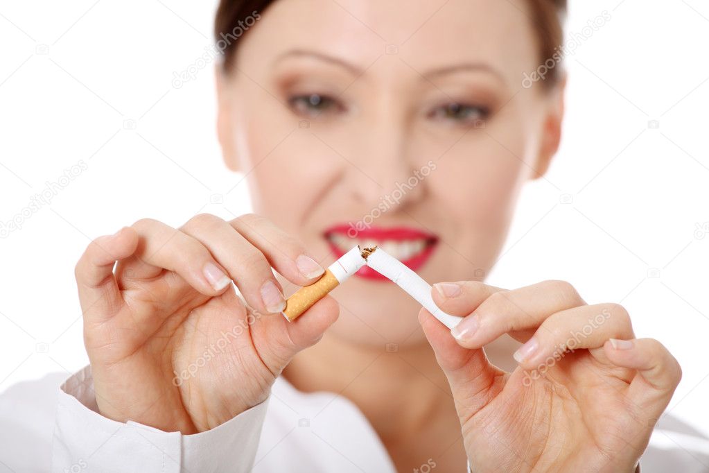 Mature woman breaking cigarette