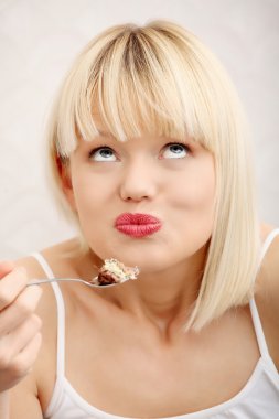 Beautiful woman's eating cake. clipart