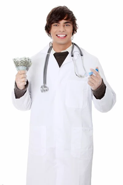 Fiatal orvos, a pénz és a fecskendő. — Stock Fotó