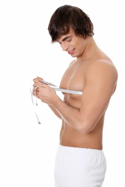 Young man's measuring himself. — Stock Photo, Image