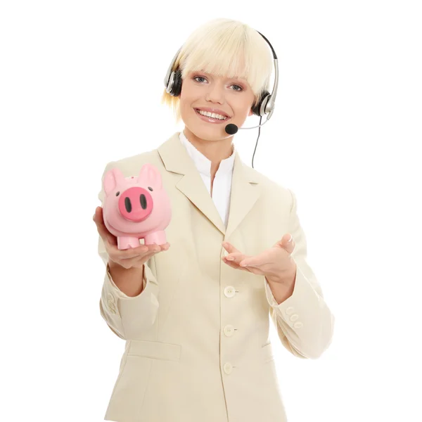 Kobieta z zestawu słuchawkowego piggy bank gospodarstwa — Zdjęcie stockowe