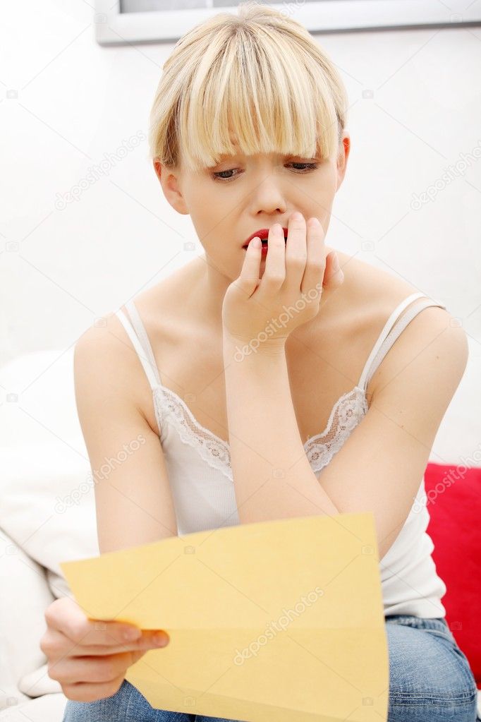 Worried woman's reading letter.