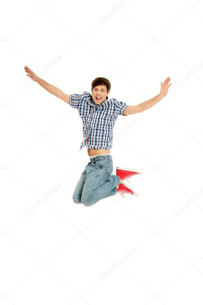 Young happy caucasian man jumping in the air