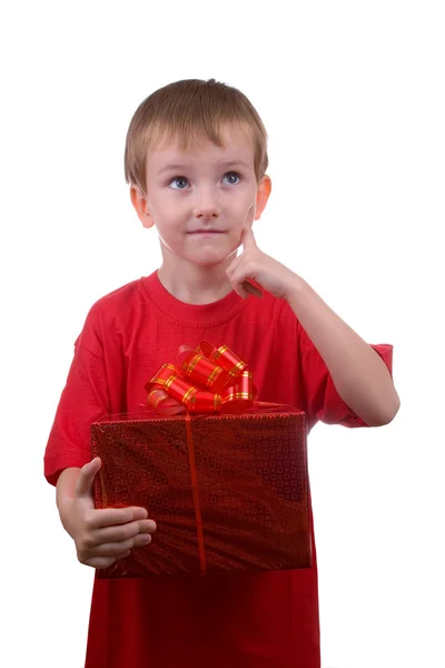 Happy boy thinks about the gift — Stock Photo, Image