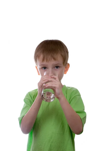 Boy drinks water from a glass — Stock Photo, Image