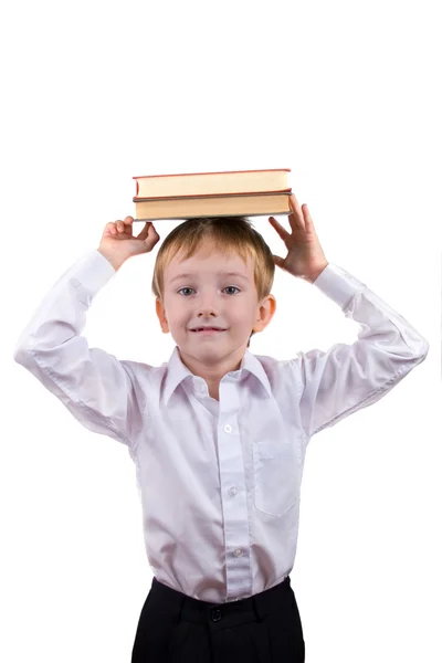 Rapaz feliz com uma pilha de livros — Fotografia de Stock