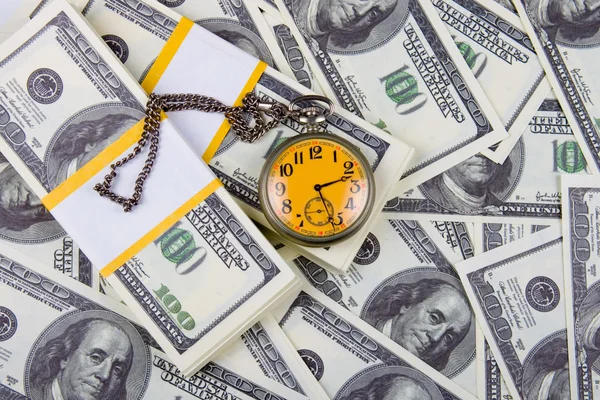 Reloj de bolsillo en una pila de dólares —  Fotos de Stock