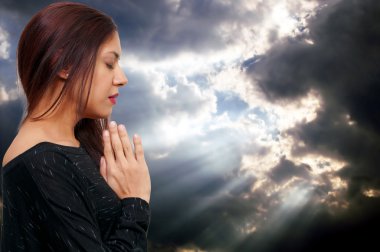 Beautiful Hispanic Latino Christian woman in deep prayer clipart