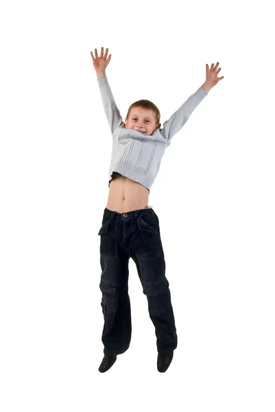 Szczęśliwy chłopiec skoki w mid. studio strzelać na biały backgro — Zdjęcie stockowe