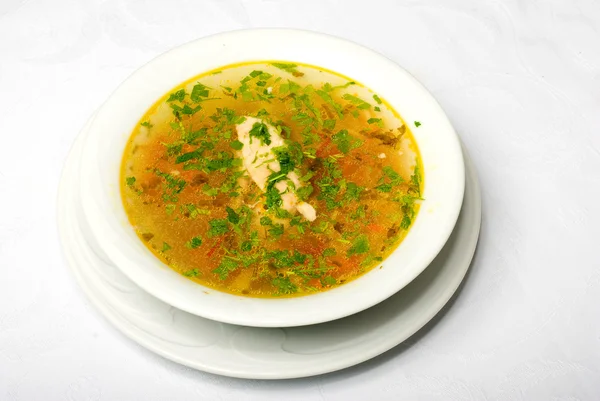 Leckere gelbe heiße Suppe auf weißem Teller — Stockfoto
