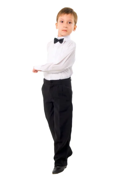 Ernster kleiner Junge tanzt über weißem Hintergrund. — Stockfoto