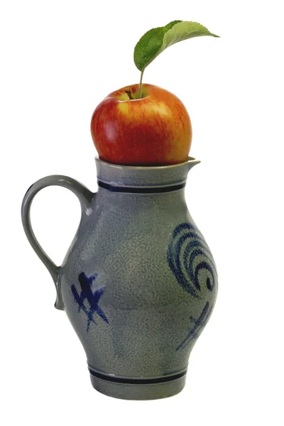 Apple in a jug — Stock Photo, Image