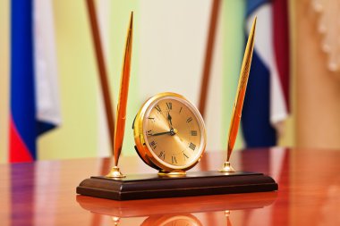 Inkstand with clock on manager table somewhere in Russia clipart