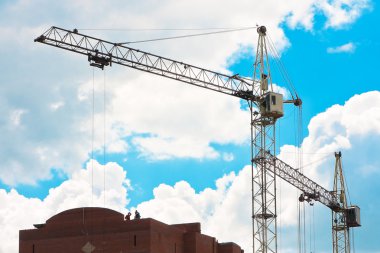 Tower cranes on the construction site clipart