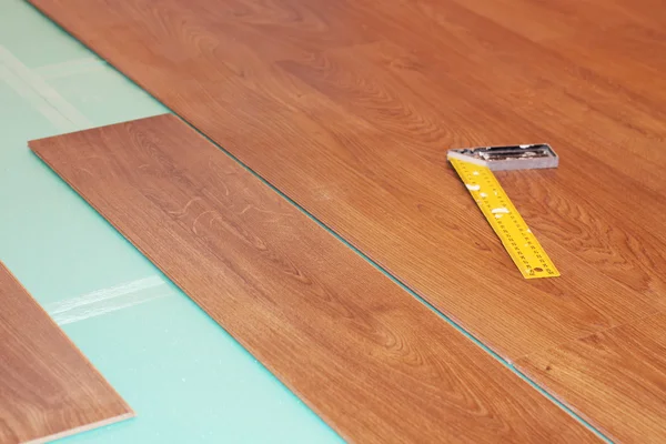 Ruler and laminate on substrate — Stock Photo, Image
