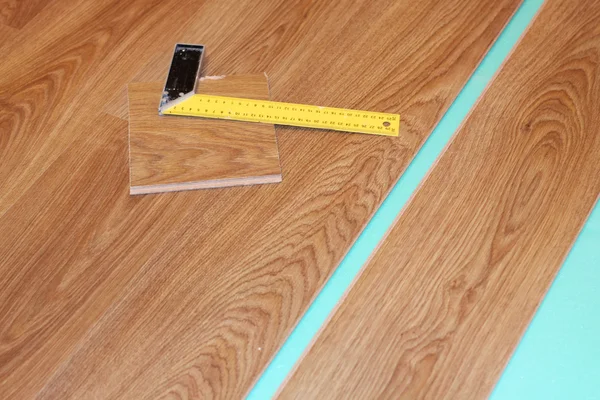 Ruler and laminate on substrate — Stock Photo, Image