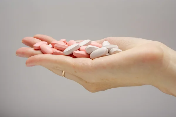 Stock image Hand full of pills