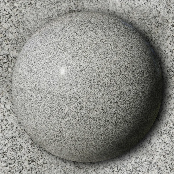 Stone sphere against polished granite surface