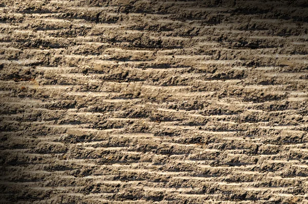 Gerillte Asphalt- oder Gesteinsoberflächenstruktur diagonal beleuchtet — Stockfoto