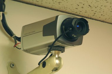 Security camera mounted on a wall clipart