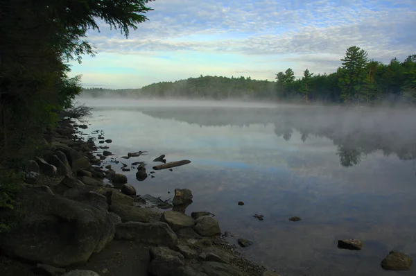 Mist rising from a lake in the wilderness — Stock Photo, Image
