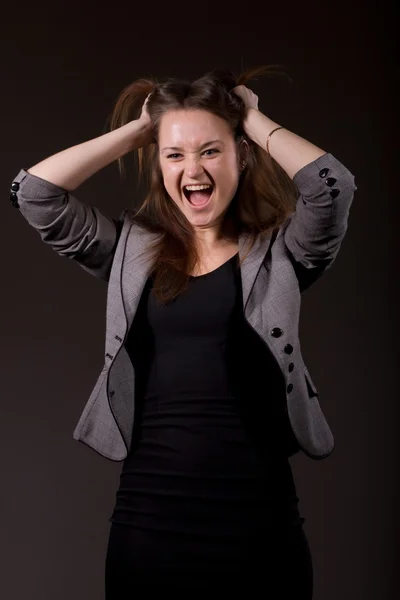 stock image Woman in business clothes screaming and holding his head.