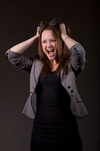 Business woman screaming, clutching his head. Stock Image