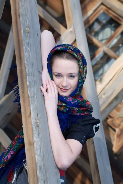 Ung, söt flicka på bakgrund av loggen av trähus. — Stockfoto