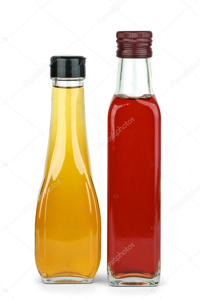 Two bottles with apple and red wine vinegar isolated on the white background