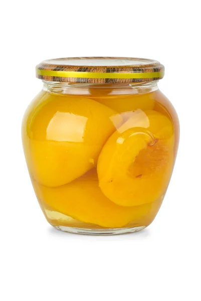 Glass jar with conserved peach fruits — Stock Photo, Image