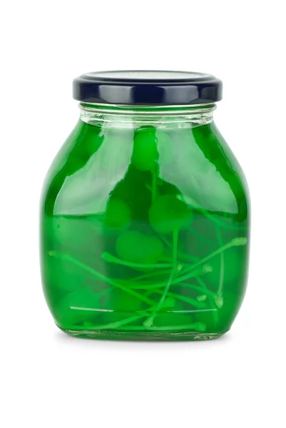 Glass jar with green cocktail cherries — Stock Photo, Image