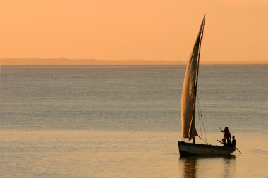 Mozambican dhow at sunset clipart