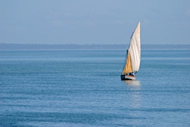 Mozambican dhow at sunset clipart