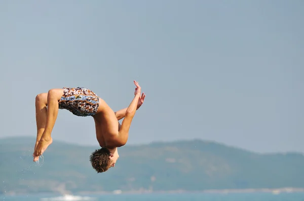 Boy jump sea — Stock Photo, Image