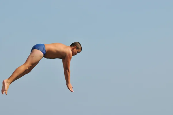 Boy jump sea Stock Picture