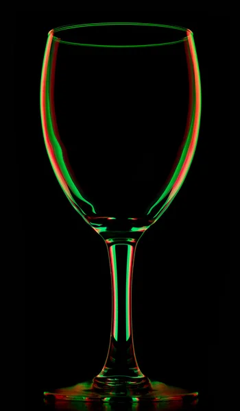 Transparent colored empty wine glass on black — Stock Photo, Image