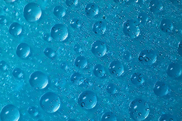 Drops of water on blue background — Stock Photo, Image