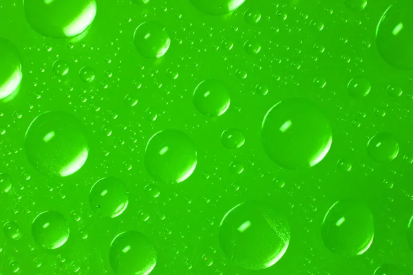 Drops of water on green background — Stock Photo, Image