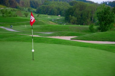 Golf flag on the green grass clipart