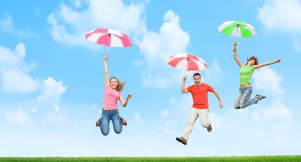 Young Friends Jumping Umbrellas — Stock Photo, Image