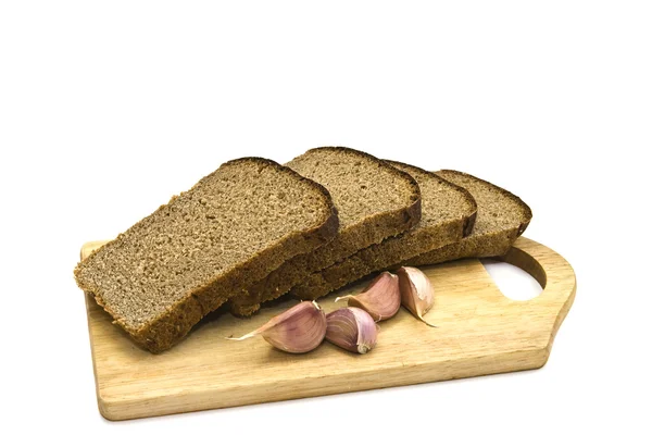 Chunks of black bread and garlic . — Stock Photo, Image