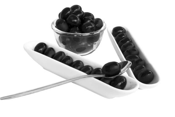 Black olives with spoon — Stock Photo, Image